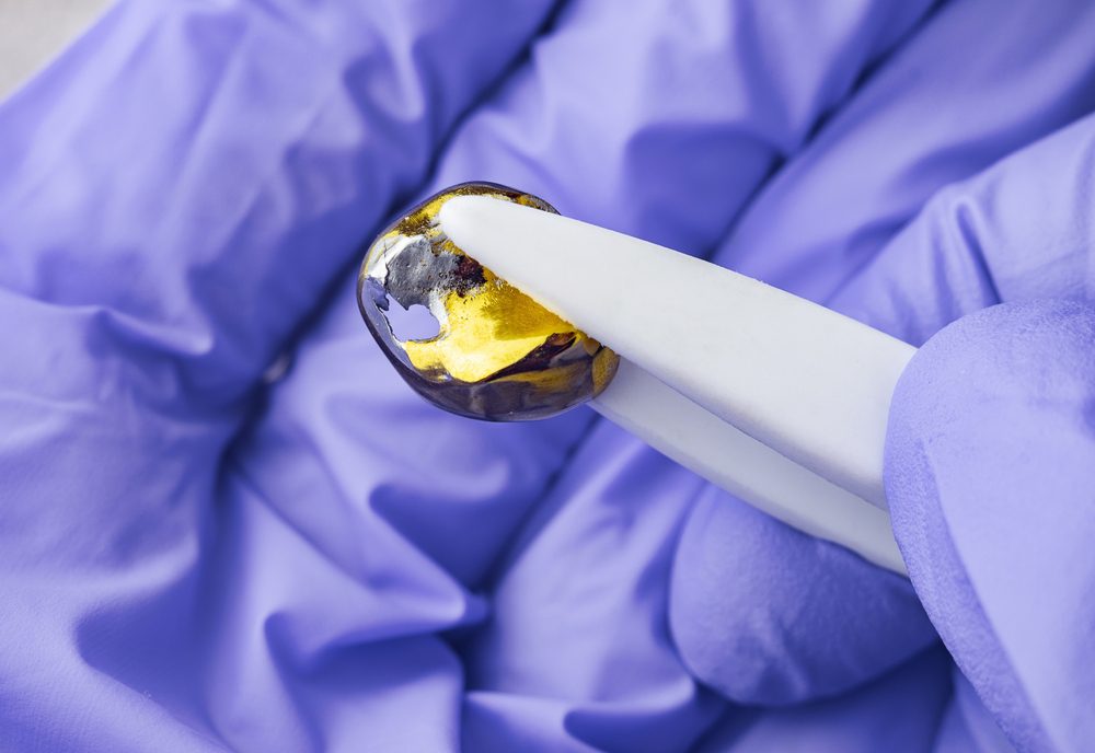 OldDeformedGolden-colorMetalDentalCrownWithCracksKinksAnd