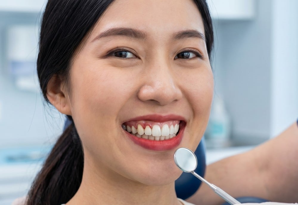 Patient having a dental checkup to identify early signs of gum recession.